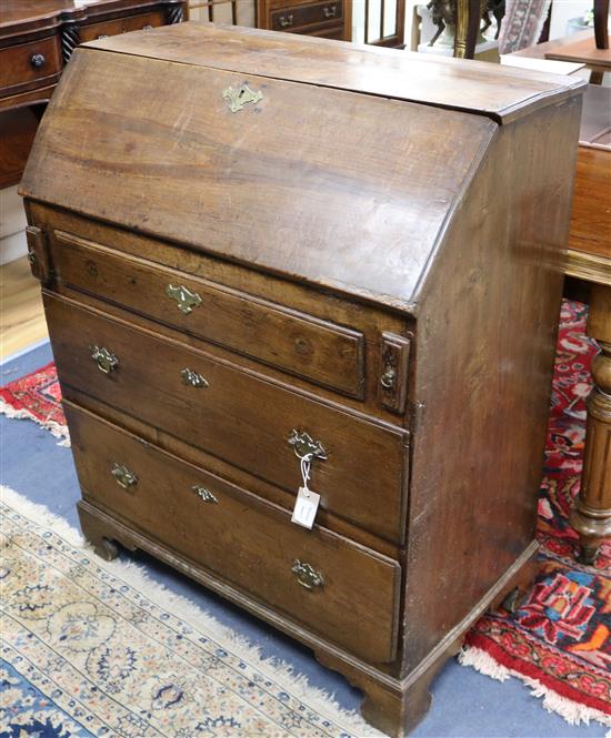 A George III oak bureau W.84cm